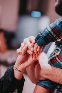 a couple holding hands while holding each other